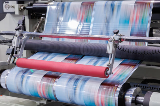new innovative technology of automatic label printing machine with digital control panel. printing on continuous plastic film for wrapping on food product packaging in the printing factory. Help with plastic packaging tax by Trademark Polythene UK